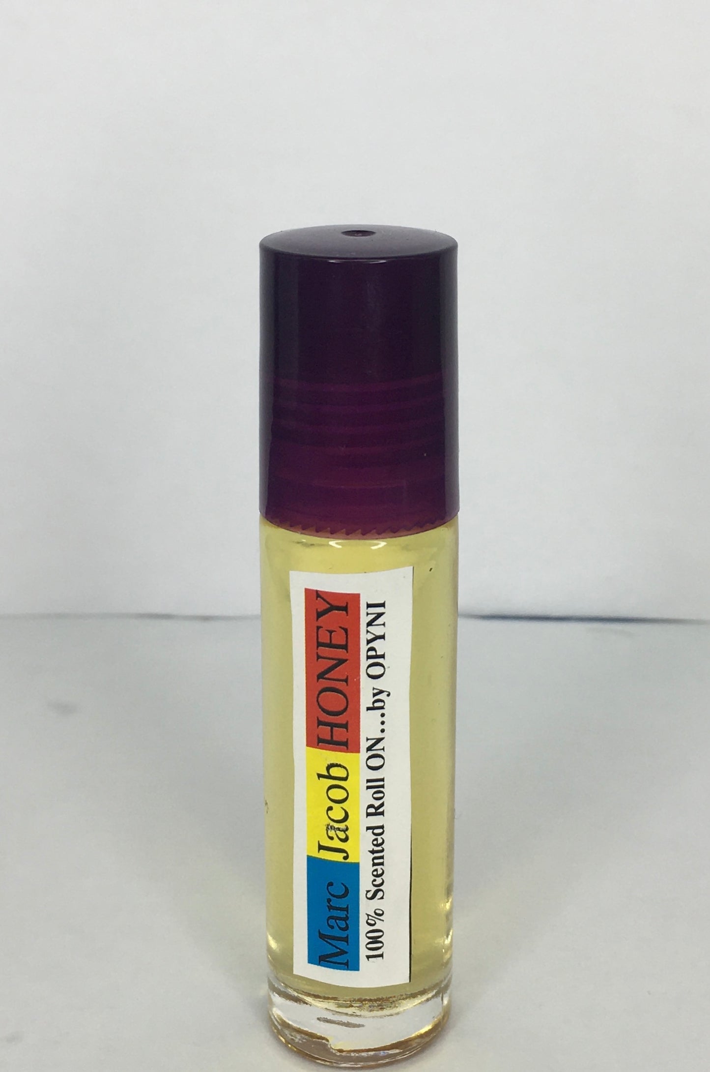 Roll-on bottle of Marc Jacob Honey by Opyneye on a white background
