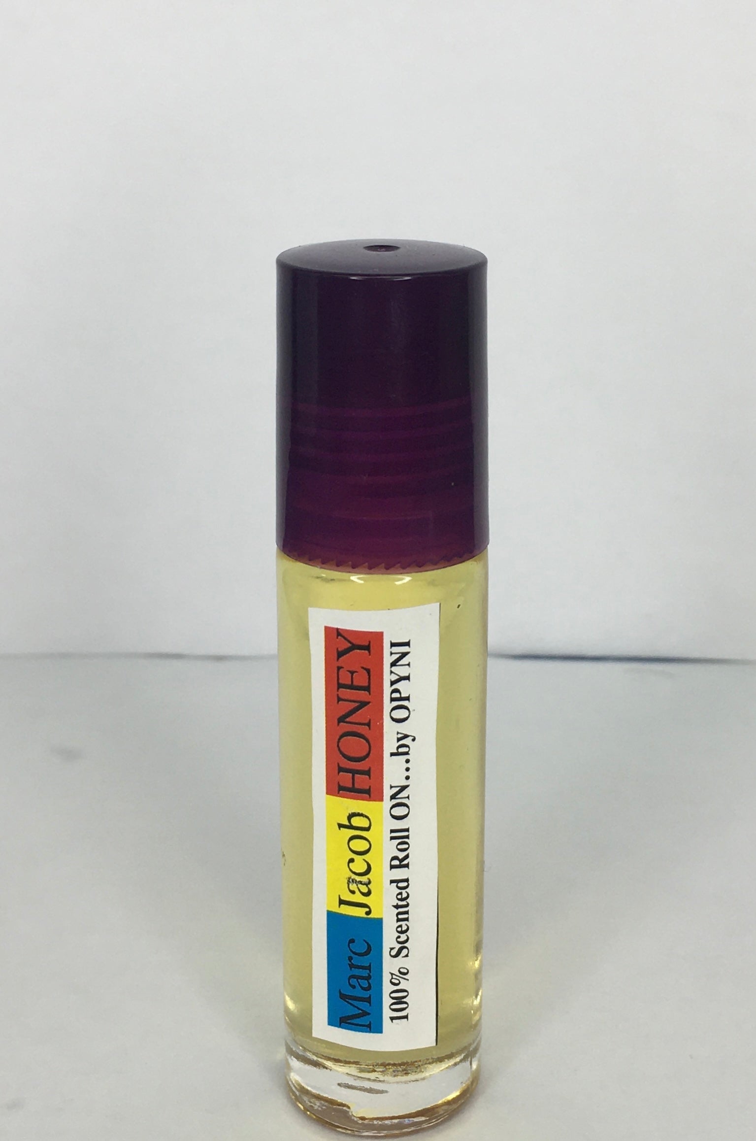 Roll-on bottle of Marc Jacob Honey by Opyneye on a white background