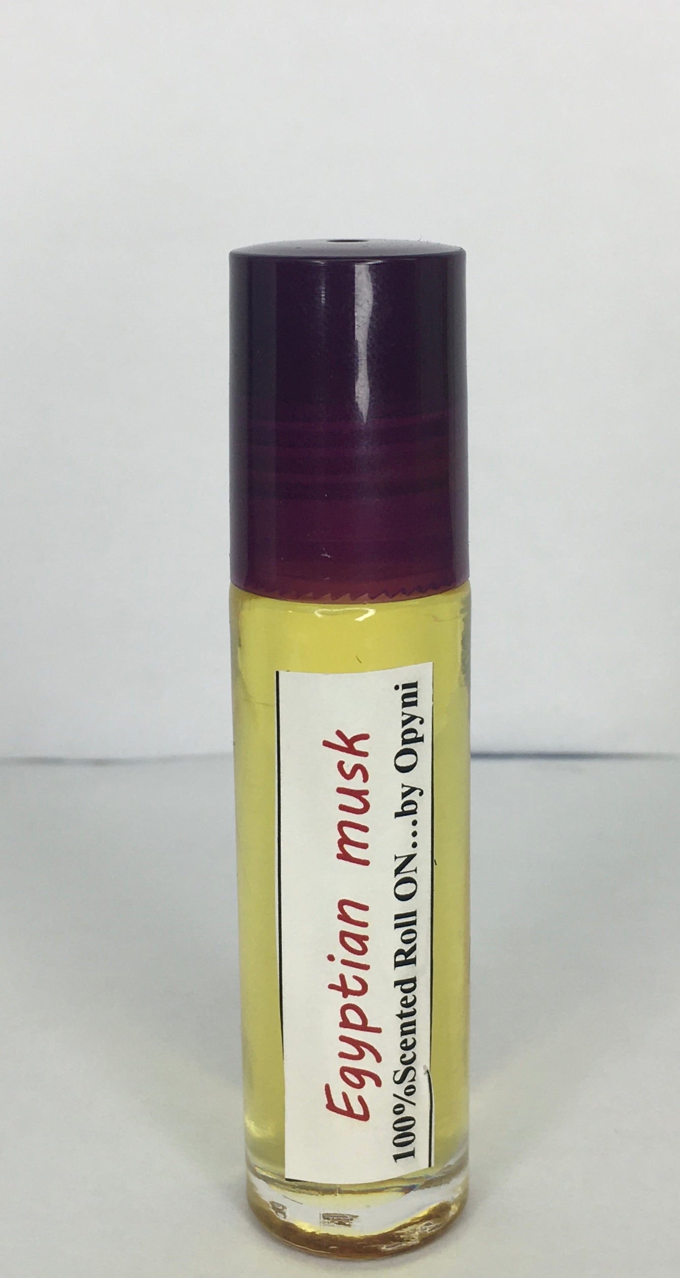 Roll-on bottle of Egyptian musk by Opyneye on a white background